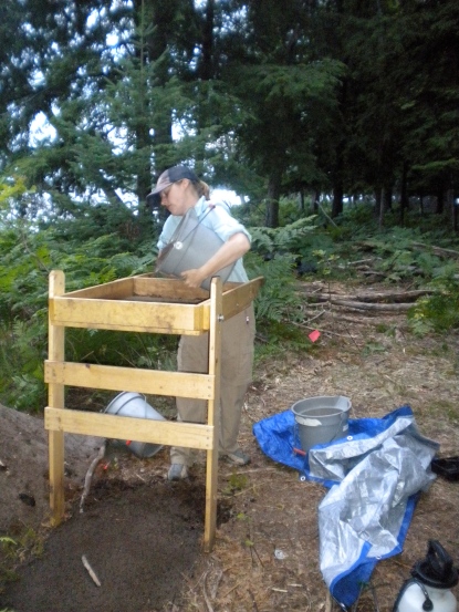 Fierce and productive archaeologist Ashley Schubert screens a bucket, hunting for artifacts in northern Michigan.